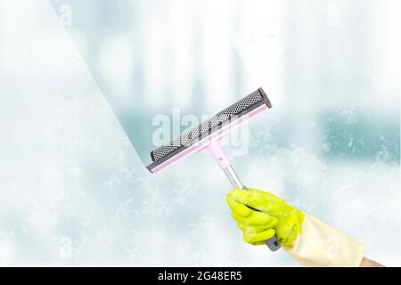 Washing windows theme. Window cleaner using a squeegee to wash a windows. Spring cleaning concept. Window cleaning brush for windows washing Stock Photo