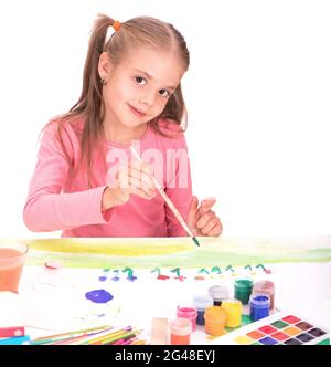 The child, a little girl draws paints isolated on white background Stock Photo