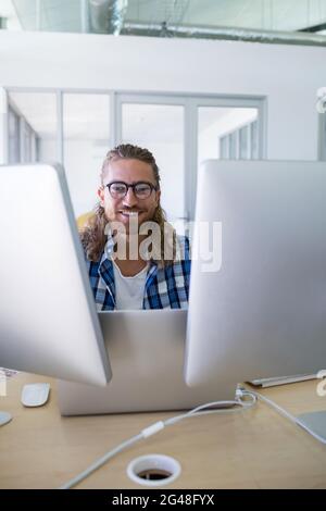 Male executive working over laptop at his desk Stock Photo