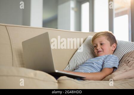 Boy using laptop in the living room Stock Photo