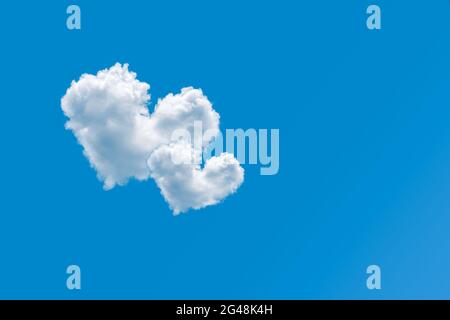 Couple of heart shaped clouds on a clear blue sky background. Concept of love and romance. Pair of cloud hearts in sky. Valentine's day design element Stock Photo