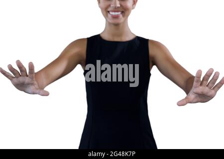 Mid section of happy young businesswoman using invisible interface Stock Photo