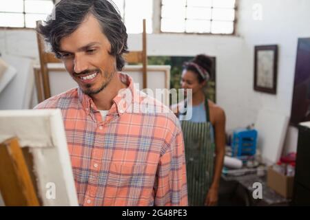 Man and woman painting on canvas Stock Photo