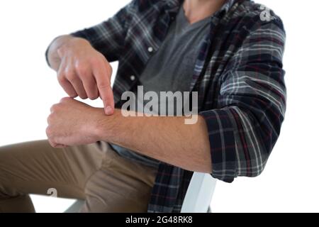 Mid section of businessman pointing on imaginary wristwatch Stock Photo