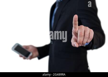 Mid section of businessman holding smartphone while using invisible interface Stock Photo