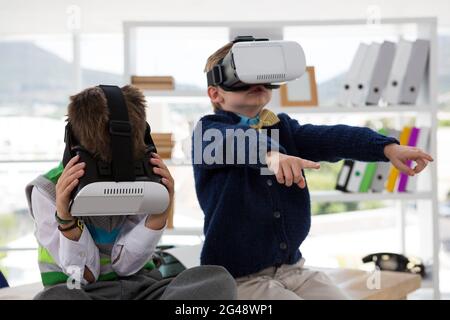 Kids as business executives using virtual reality headset Stock Photo