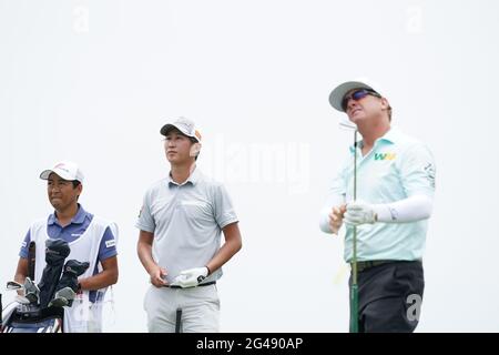 Rikuya Hoshino and caddie watch the the tee shot by Charley Hoffman on the 8th hole during the third round of the 2021 U.S. Open Championship in golf at Torrey Pines Golf Course in San Diego, California, USA on June 19, 2021. Credit: J.D. Cuban/AFLO/Alamy Live News Stock Photo