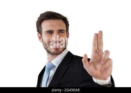 Smiling businessman touching invisible interface Stock Photo