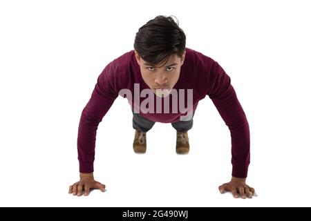 Portrait of young businessman doing push ups Stock Photo