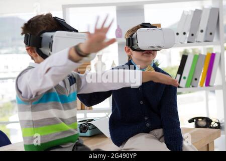 Kids as business executives using virtual reality headset Stock Photo