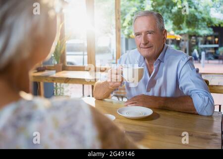 Senior couple interacting while having coffee Stock Photo