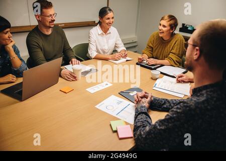 Group of business people having meeting in office. Corporate professionals having strategy meeting in office boardroom. Stock Photo
