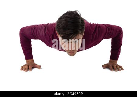 Portrait of young creative businessman doing push ups Stock Photo