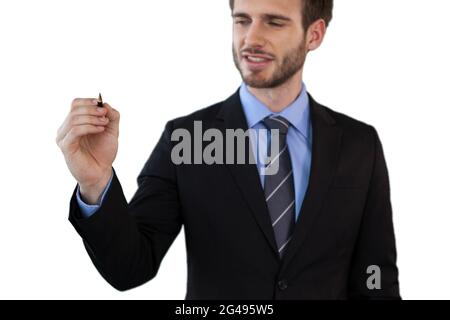 Smiling businessman writing on invisible interface Stock Photo