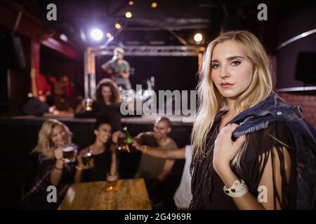 Portrait of woman with friends in background Stock Photo