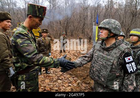 Nov 22, 2018-Cheorwon, South Korea-In this photo, provided by South Korea's defense ministry, shows South and North Korean troops during a recent operation near the Military Demarcation Line to construct a tactical road to support a joint project to excavate Korean War remains in the Demilitarized Zone. Stock Photo