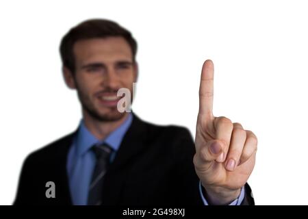 Close up of smiling businessman touching index finger on invisible interface Stock Photo