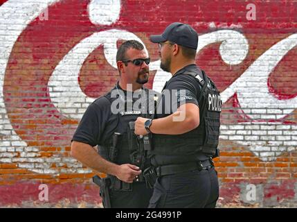 Council Grove police Chief Shawn Wangerin talks with police officer Viktor Massie during the Washunga Days parade Stock Photo