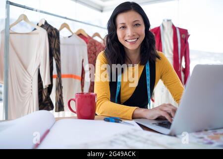 Female designer using laptop Stock Photo