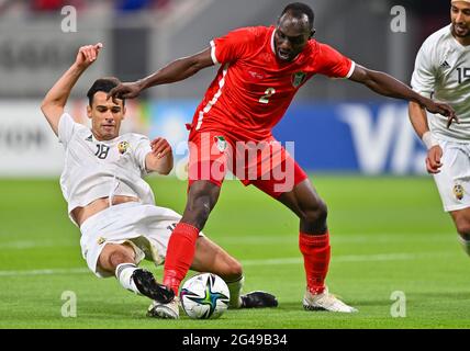 Doha, Qatar. 19th June, 2021. Abuaagla Abdalla (R) of Sudan vies with Faisal Albadri of Libya during the FIFA Arab Cup Qatar 2021 qualifying round football match in Doha, Qatar, June 19, 2021. Credit: Nikku /Xinhua/Alamy Live News Stock Photo