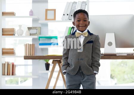 Portrait of boy imitating at businessman Stock Photo