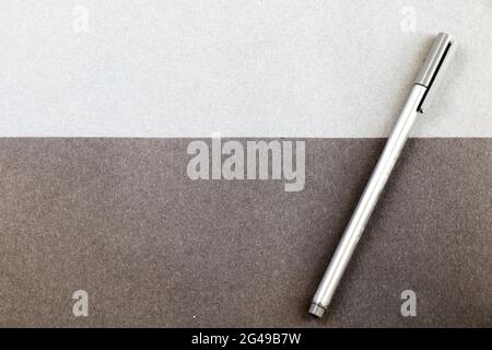 A gray pen on the black and gray papers background for a copy space Stock Photo