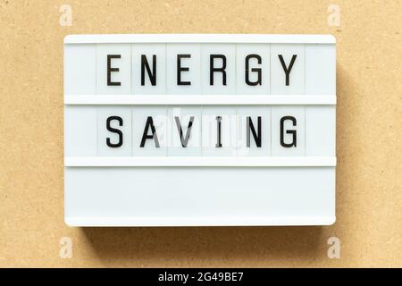Lightbox with word energy saving on wood background Stock Photo