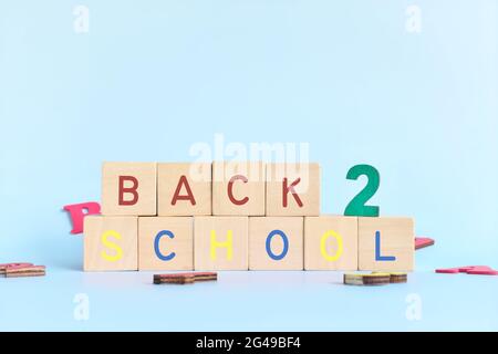 Colorful back to school typography in wooden blocks in blue background. Stock Photo
