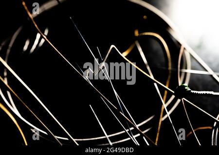 Abstract Closeup of End on Used Bronze Acoustic Guitar String in Front of Other Loose Strings Stock Photo