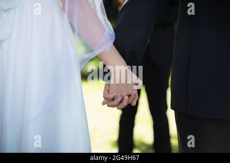 Mid section of couple holding hands Stock Photo
