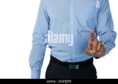 Mid section of businessman touching invisible screen Stock Photo