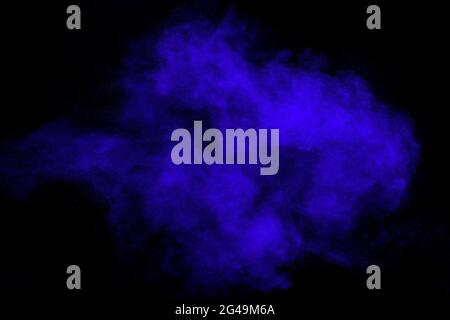 Blue color dust particles splash on black background. Stock Photo