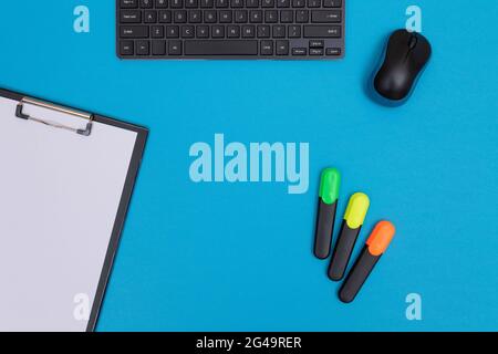 Office Workplace with Digital Gadgets Lying on Blue Table - Flat Lay Stock Photo