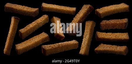 Rye bread croutons on black background, collection Stock Photo