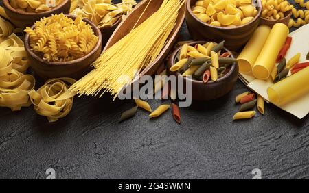 Different pasta types on black background with copy space for text Stock Photo