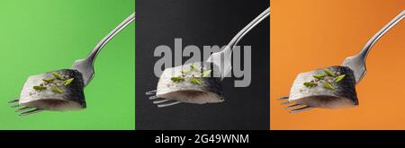 Pieces of salted herring on fork Stock Photo