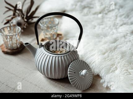 Close-up of a teapot in a Scandinavian style with tea. Stock Photo