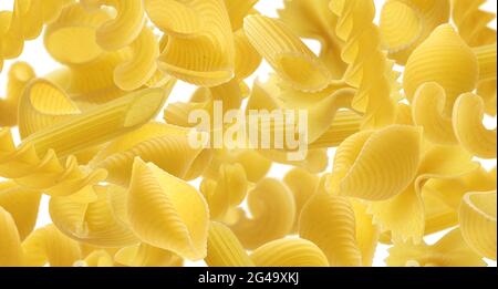 Italian pasta texture, different pasta types falling over white background Stock Photo