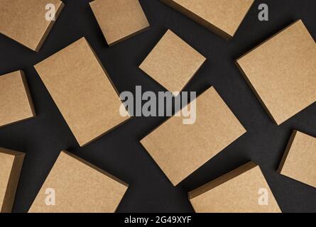 Brown cardboard boxes on black background, top view Stock Photo