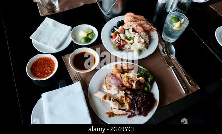 Five Star Lunch Buffet Smorgasbord Food on the Table in Pattaya Thailand all you can eat pile it on food on the plate Stock Photo