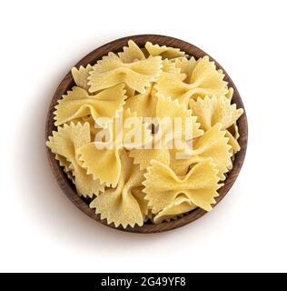 Farfalle pasta in wooden bowl isolated on white background, top view Stock Photo