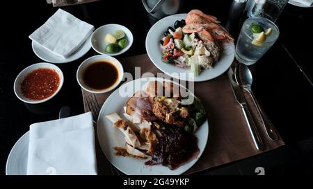 Five Star Lunch Buffet Smorgasbord Food on the Table in Pattaya Thailand all you can eat pile it on food on the plate Stock Photo