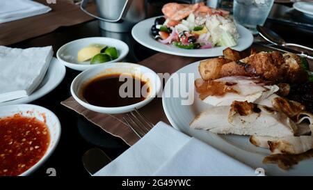 Five Star Lunch Buffet Smorgasbord Food on the Table in Pattaya Thailand all you can eat pile it on food on the plate Stock Photo