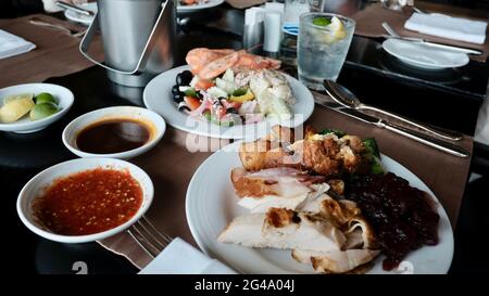 Five Star Lunch Buffet Smorgasbord Food on the Table in Pattaya Thailand all you can eat pile it on food on the plate Stock Photo