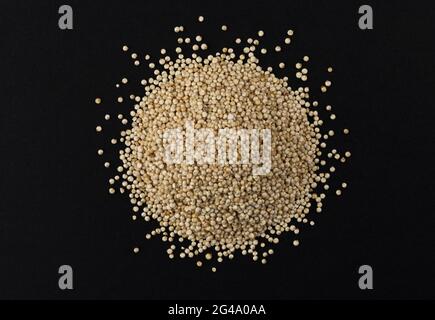Heap of quinoa seeds isolated on black background Stock Photo