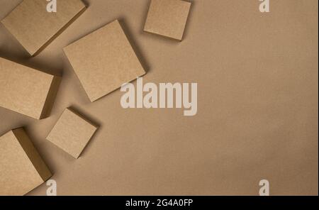 Brown cardboard boxes on craft paper background, top view Stock Photo