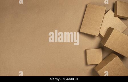 Brown cardboard boxes on craft paper background, top view Stock Photo