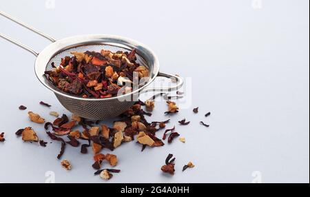 Tea strainer with tea leaves and fruits and berries Stock Photo