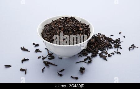 Dry black tea leaves isolated on white background Stock Photo