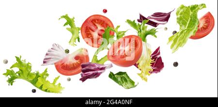 Falling salad of leaves with rucola, lettuce, radicchio, romano green frize and tomatoes Stock Photo